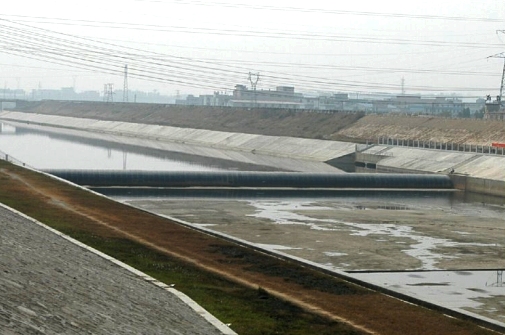 Photo 16 - Shima River Sewage Diversion Works - Rubber Dam spanning across Shima River.