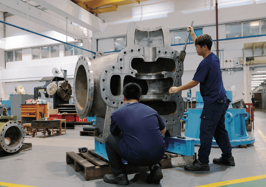 Maintenance staff inspecting the joint surface of the pump